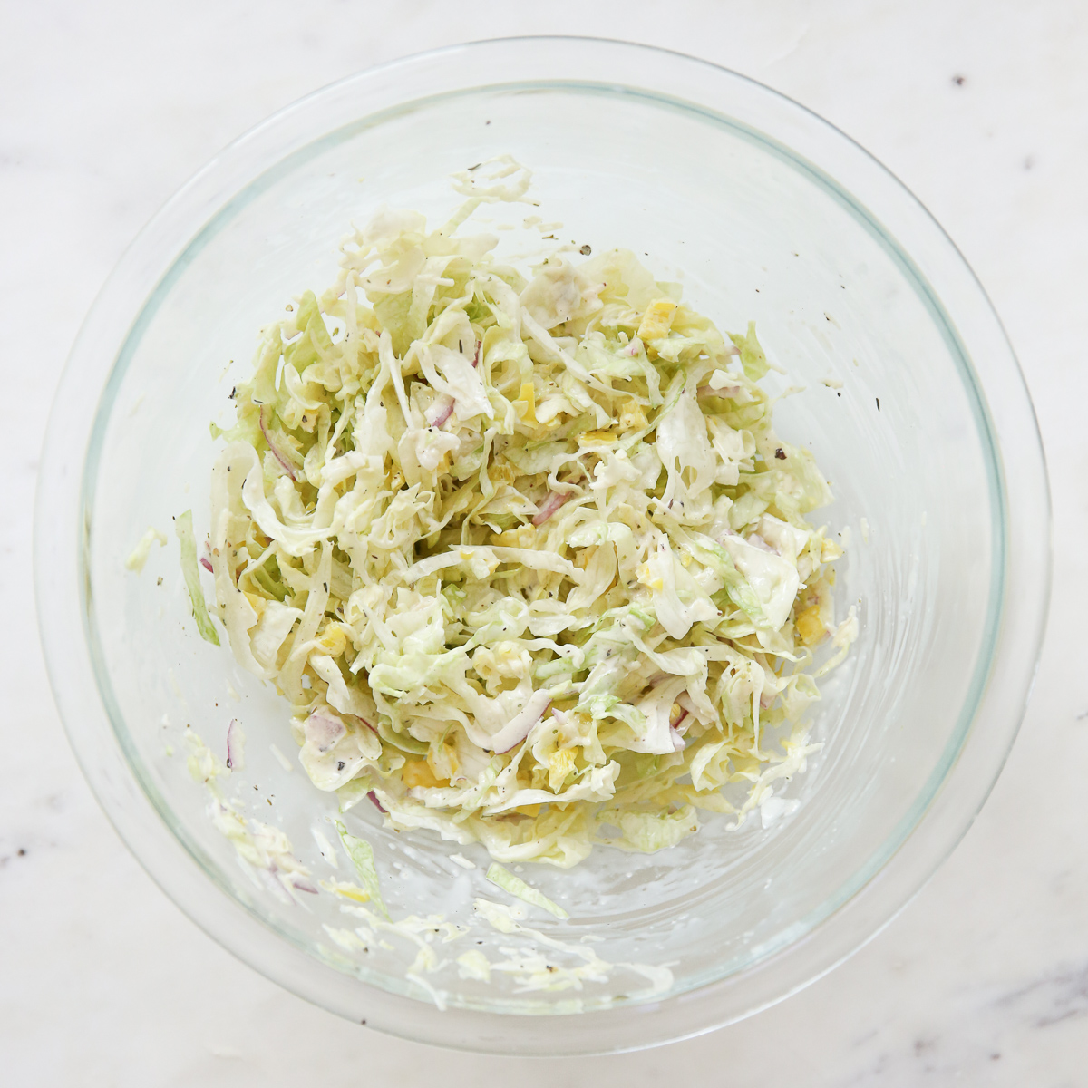 Italian grinder salad mixed in a glass bowl