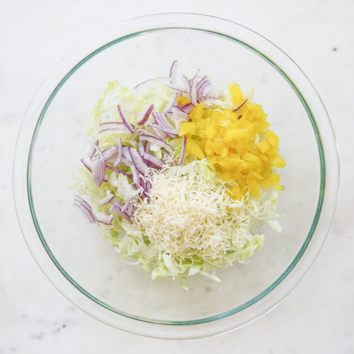 Italian Grinder Salad ingredients in a glass bowl