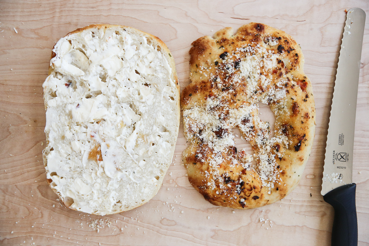 assembling an Italian grinder sandwich on a cutting board