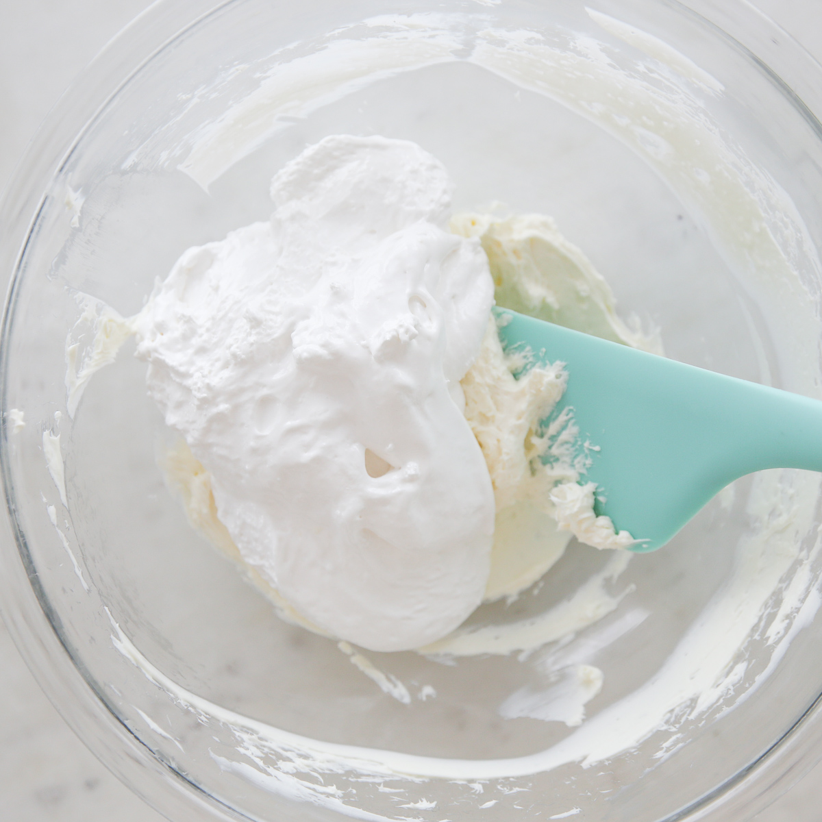 combining cream cheese and marshmallow fluff