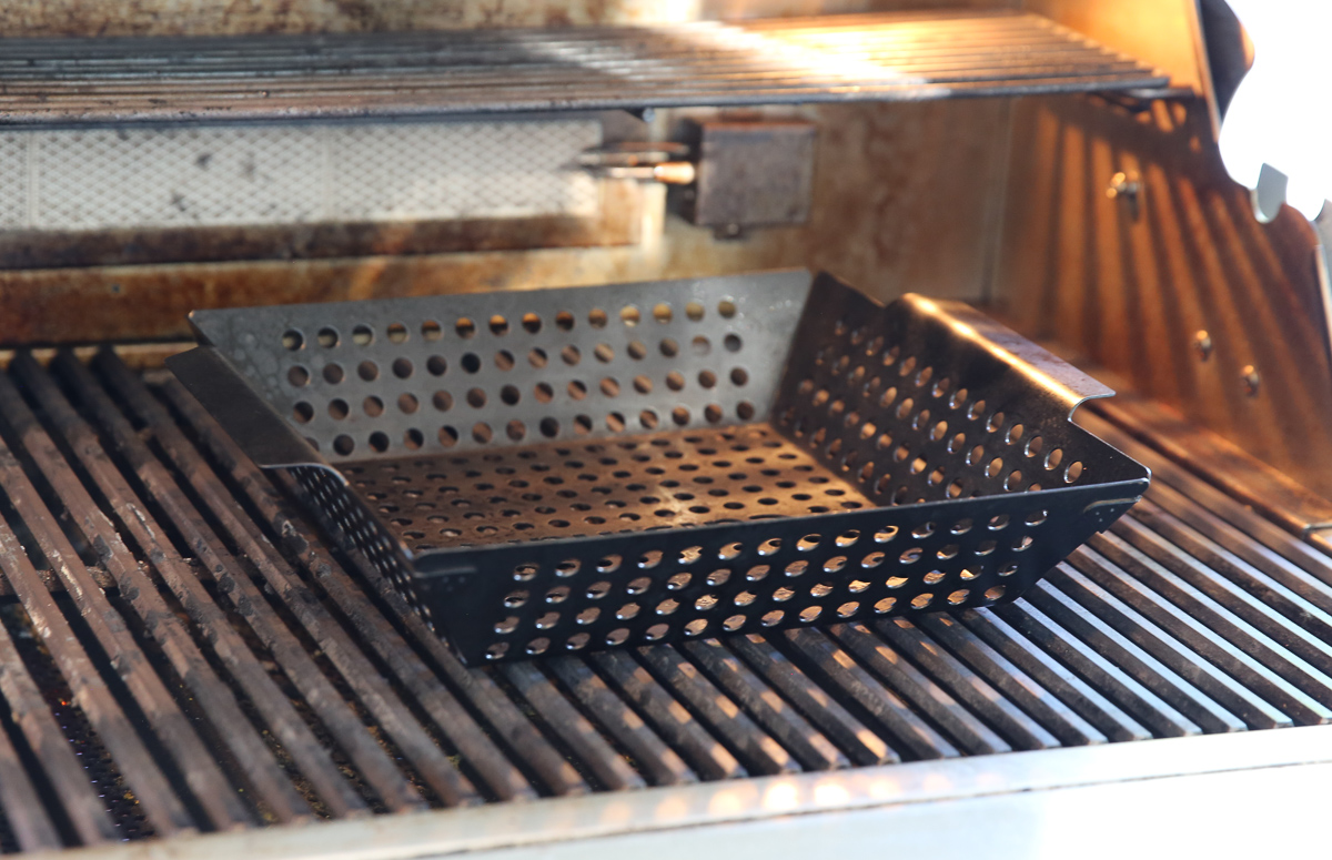 vegetables cooking in a grill basket