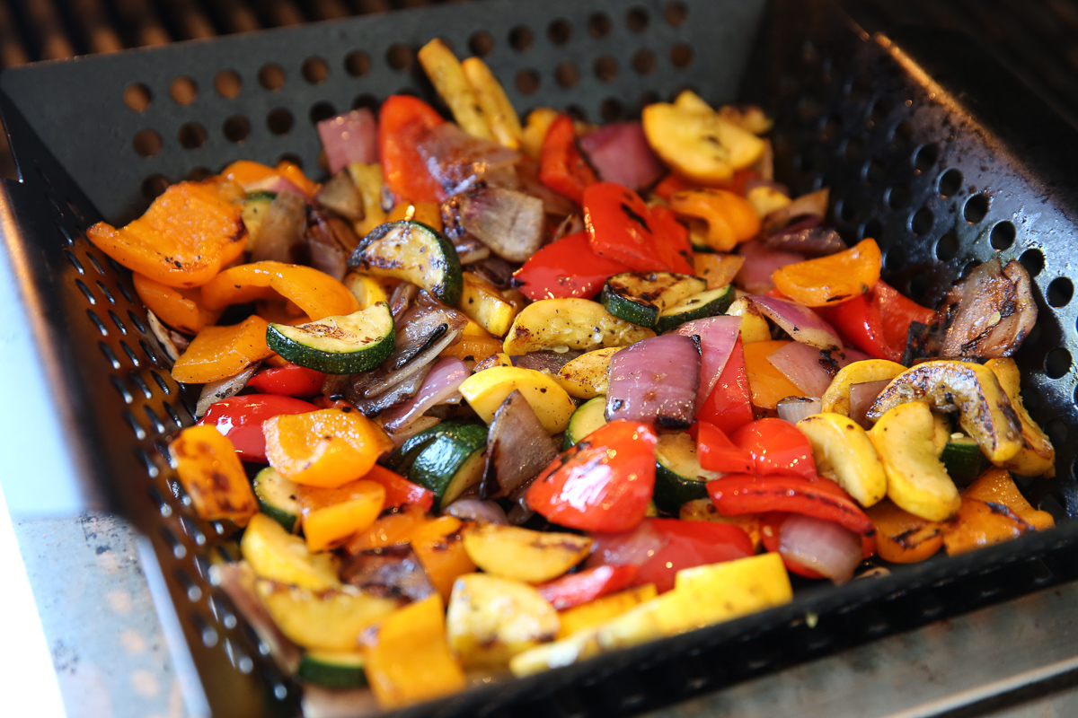 vegetables cooking in a grill basket