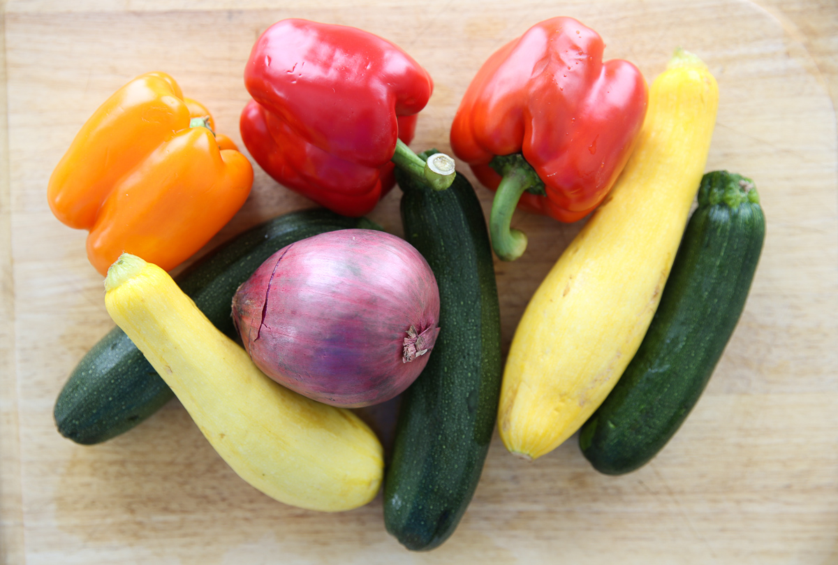 pile of fresh vegetables on a cutting board