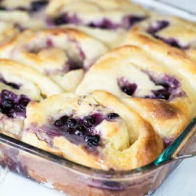 A pan of blueberry lemon rolls, hot out of the oven.