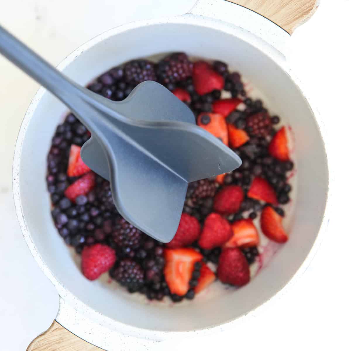 fruit in a measuring cup being smashed