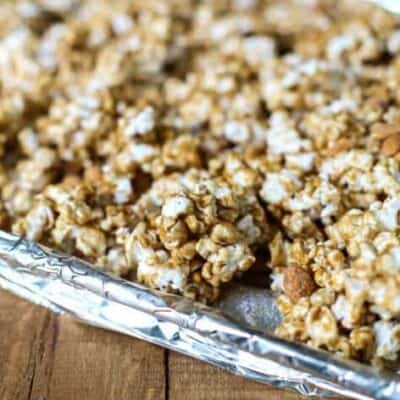 Crispy salted caramel popcorn on a baking sheet.