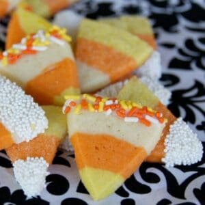 A pile of cute sugar cookies that look like pieces of candy corn.