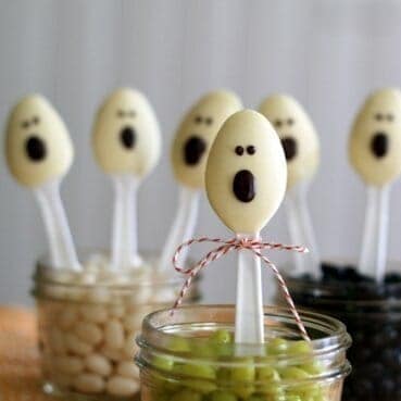 Cute plastic spoons, dipped in white chocolate, with a semisweet chocolate face.