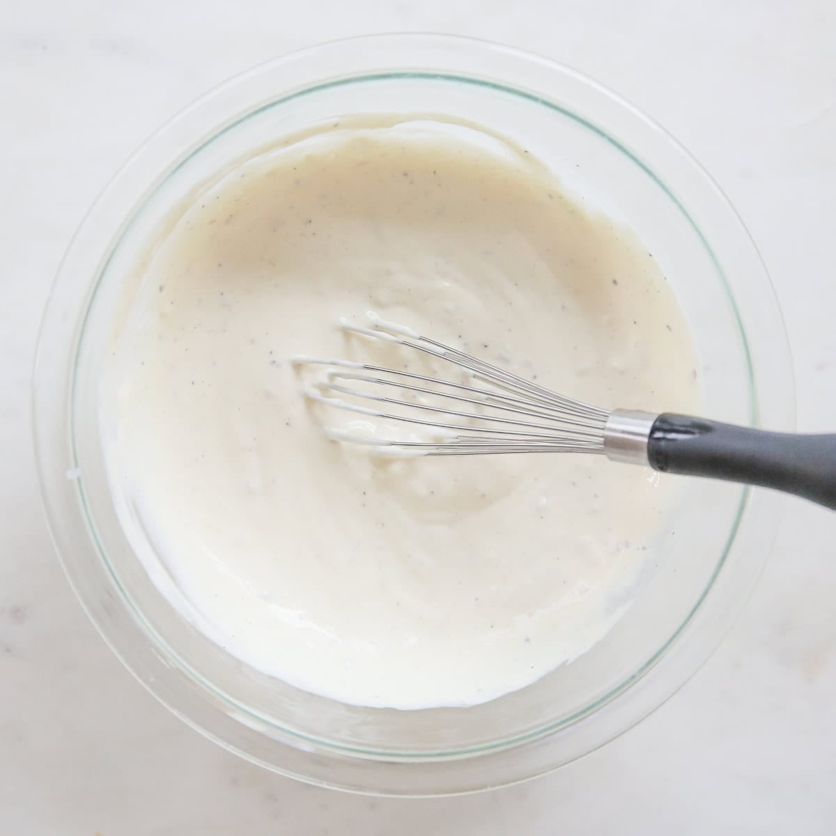 pasta salad dressing in a glass bowl