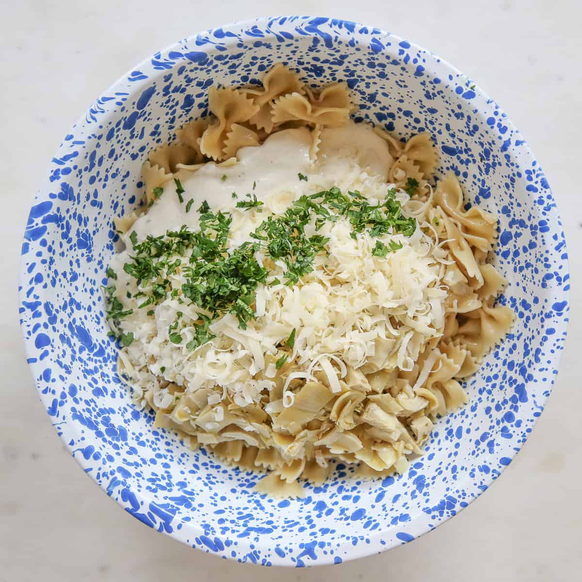 pasta salad ingredients in a mixing bowl