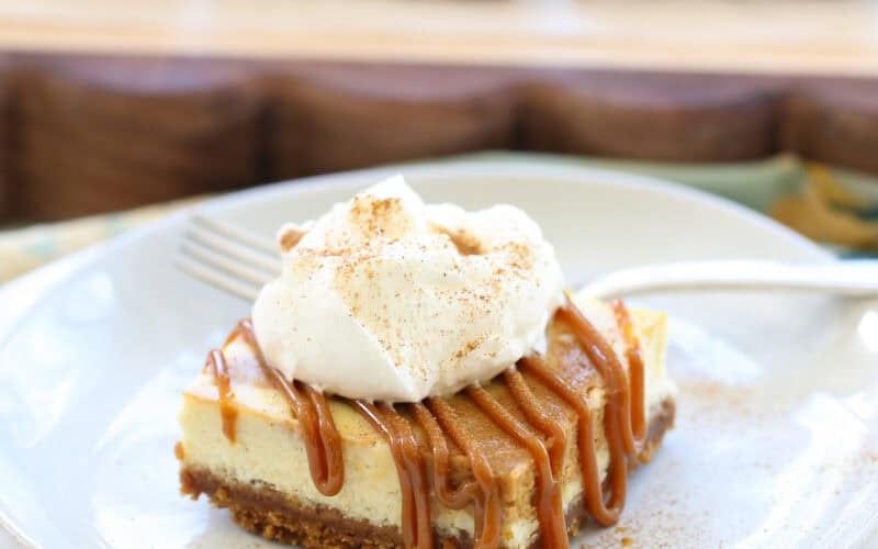 slice of dulce de leche cheesecake on a white plate