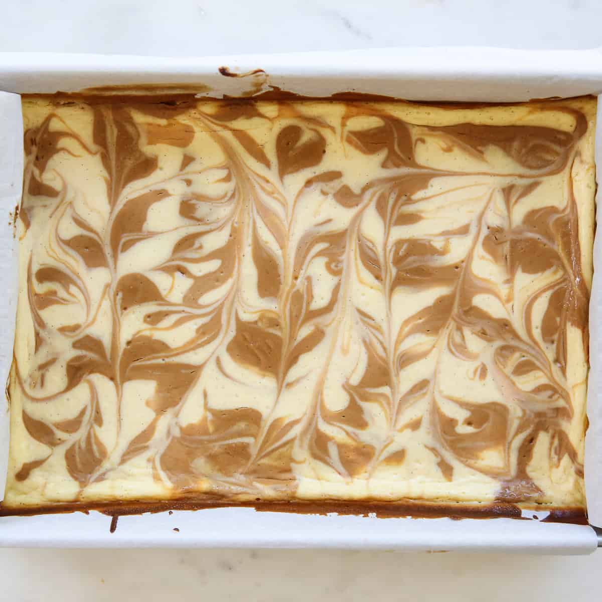swirled dulce de leche batter in cheesecake