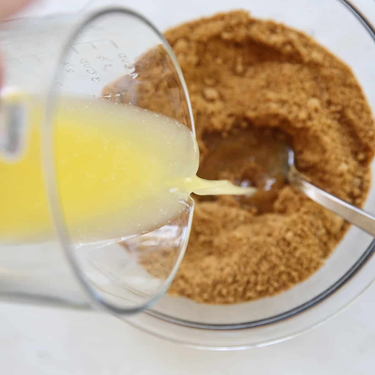 pouring butter into crumb crust