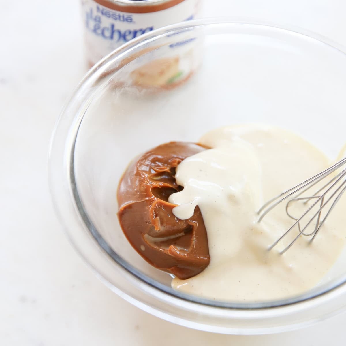 whisking dulce de leche and cheesecake batter