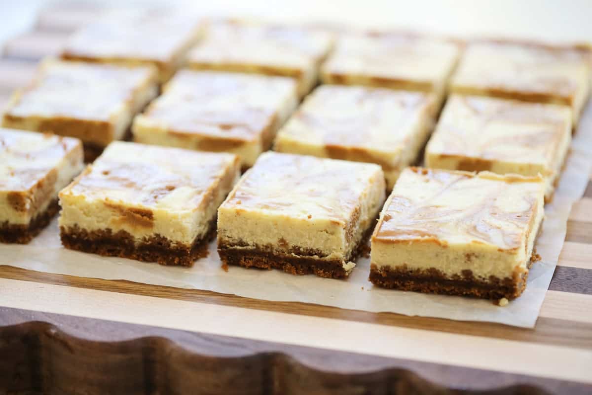sliced cheesecake bars on a cutting board