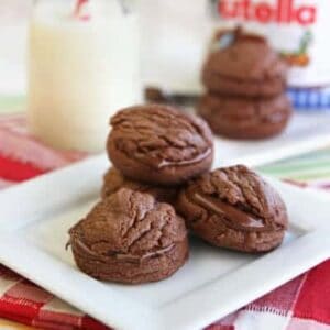 A stack of Nutella sandwich cookies on a white plate.